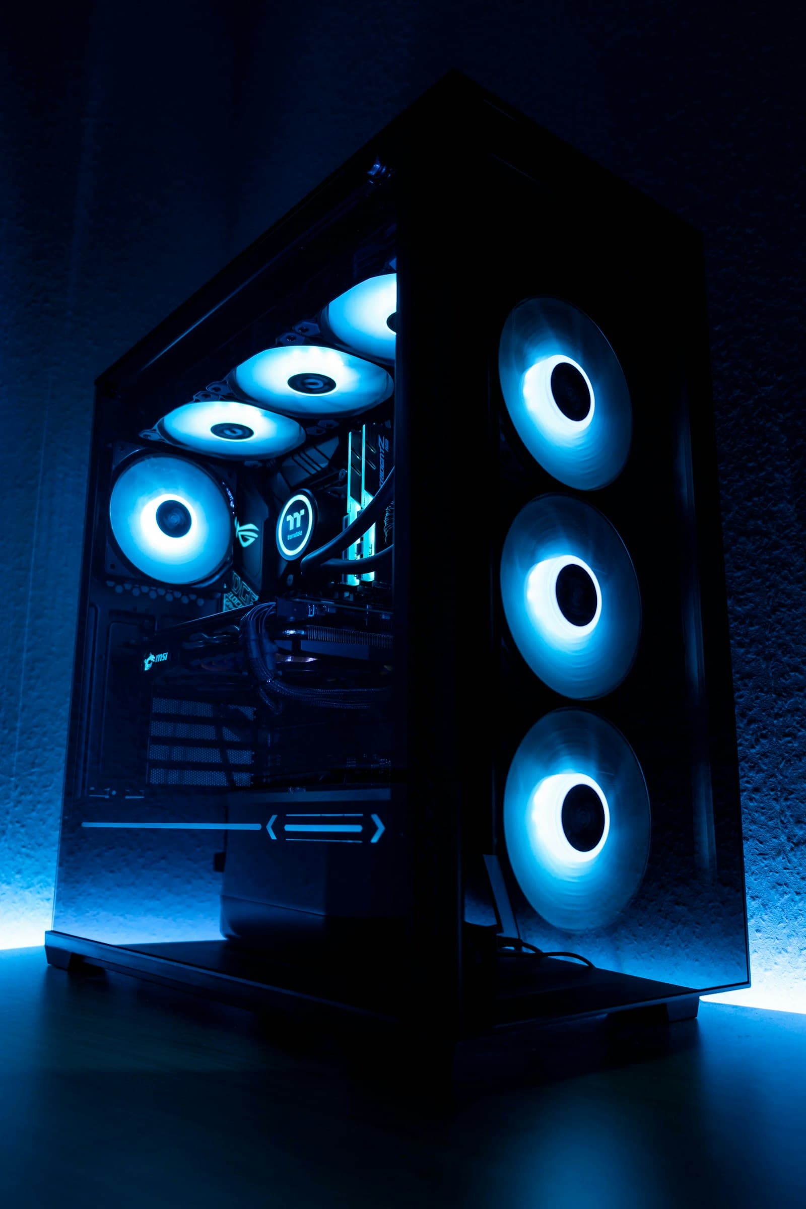 The interior of a mid-tower PC case with three illuminated intake fans
